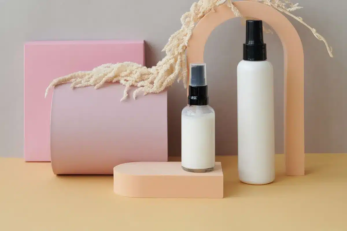 A stylish arrangement of geometric-shaped perfume bottles in soft colors, enhancing skincare product displays.