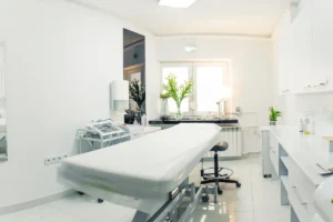 A clean and inviting spa room with a comfortable bed, ideal for facial treatments.